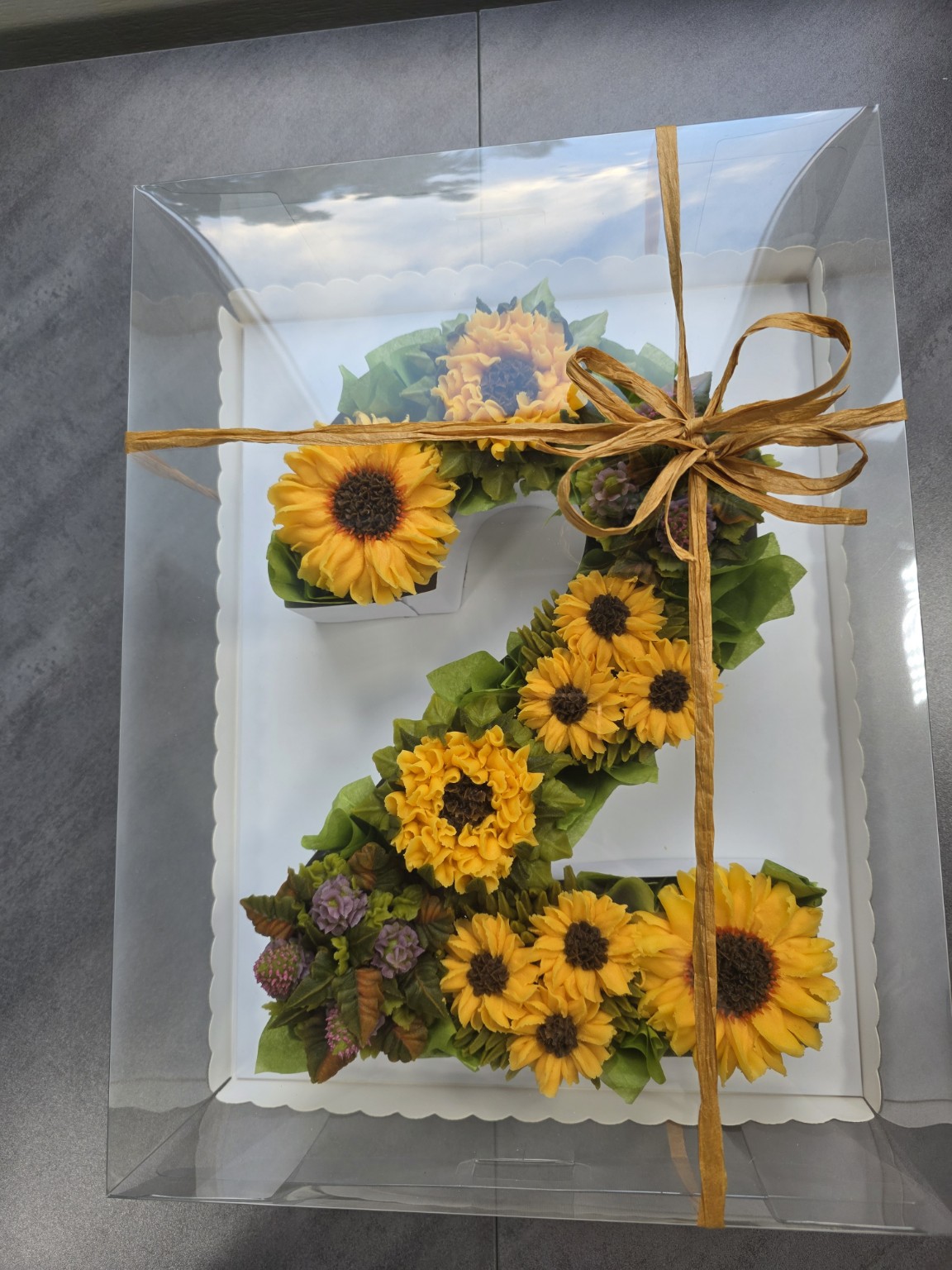 Sunflower cupcakes arranged as number 7 in a gift box